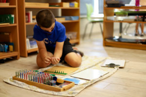 Elementary student working with Montessori Materials