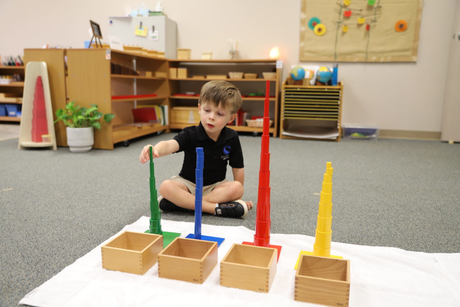 Primary student working with knobbles cylinders